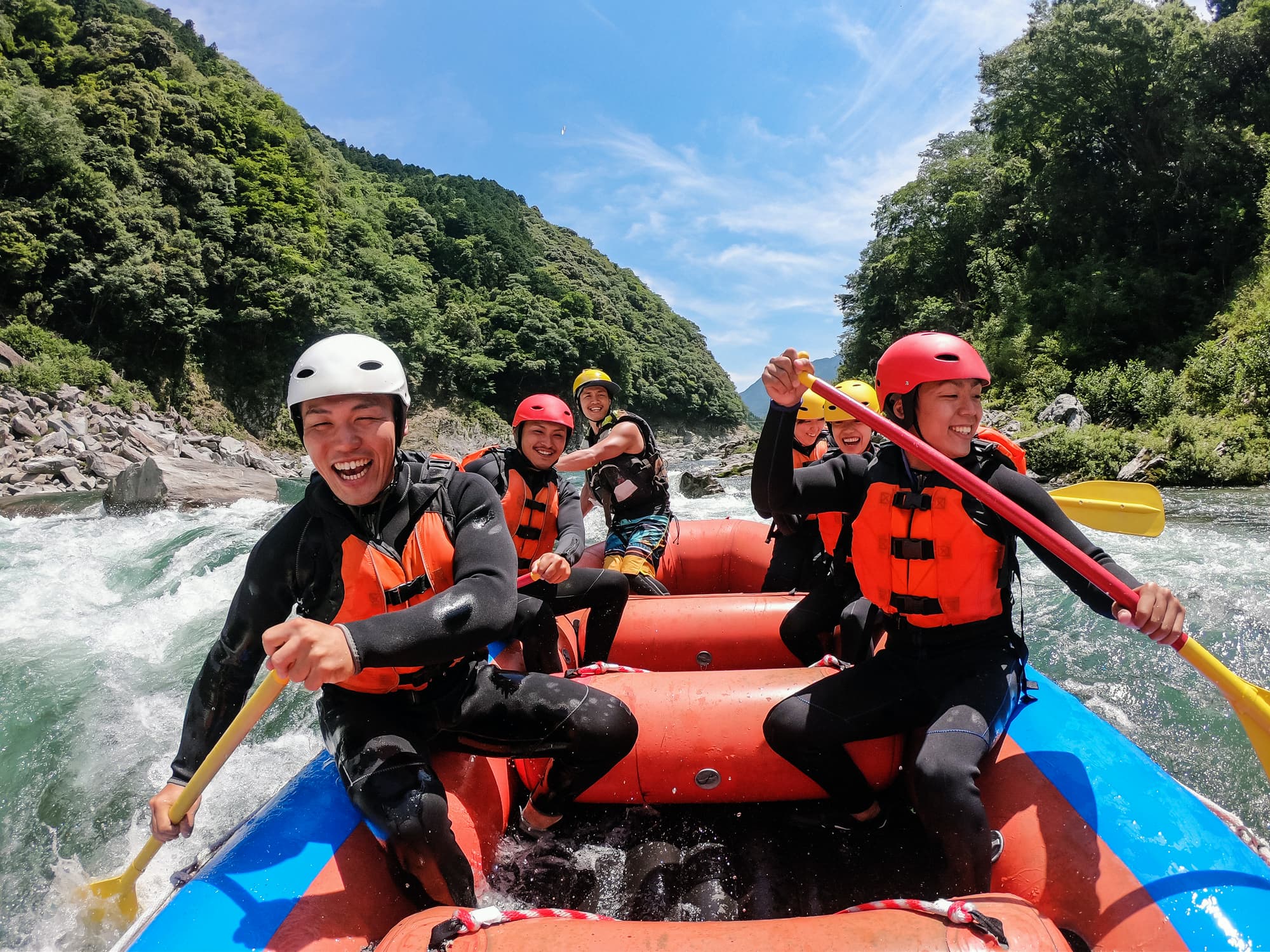 six people in a raft on a river