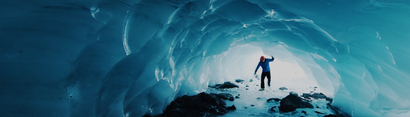 Man walking in an ice cave
